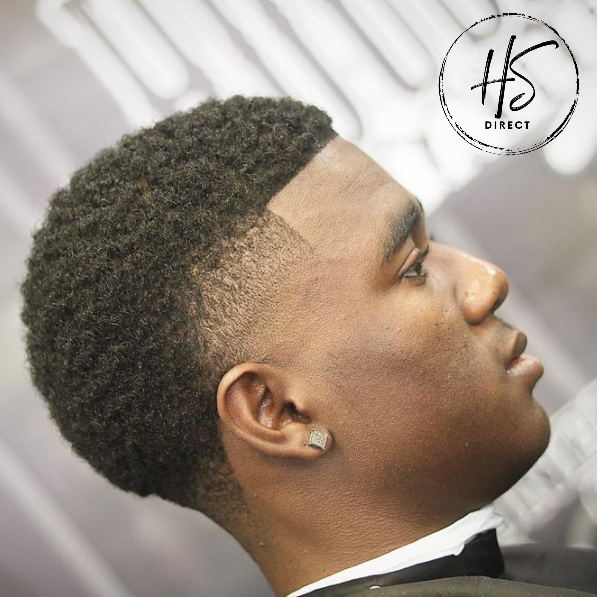 Man with styled hair looking upwards, with 'HS Direct' logo in the corner. Mens afro hair pieces and hair systems